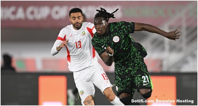 Mozambique's forward #13 Stanley Ratifo and Nigeria's defender #21 Calvin Bassey compete for the ball 